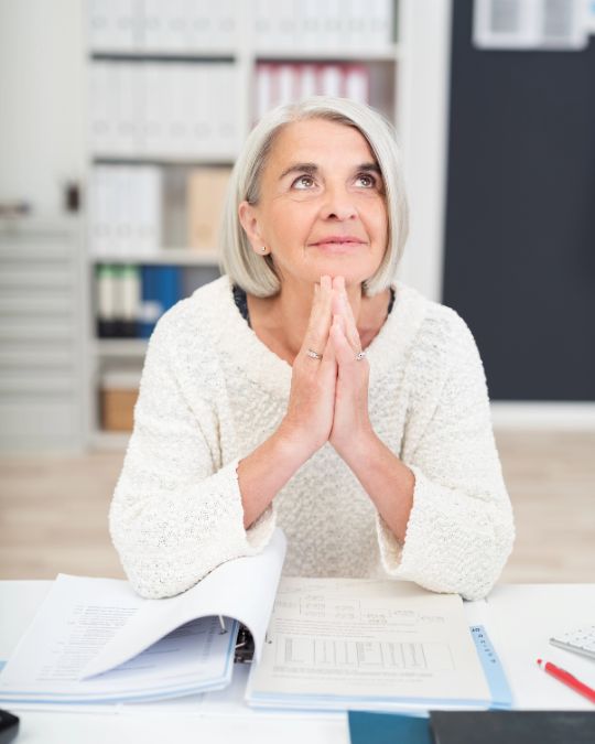 Woman sitting at her desk planning.